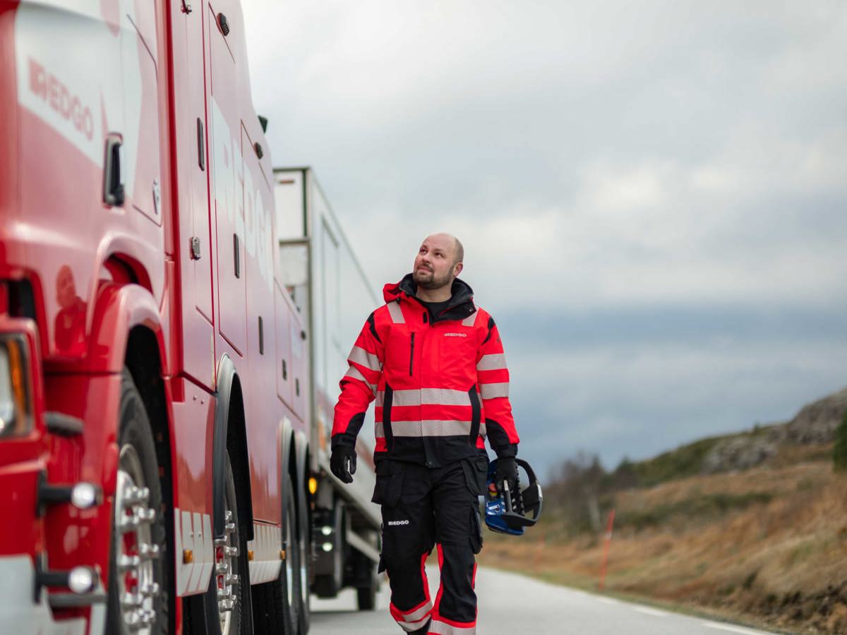 RedGo employee looking at RedGo van.